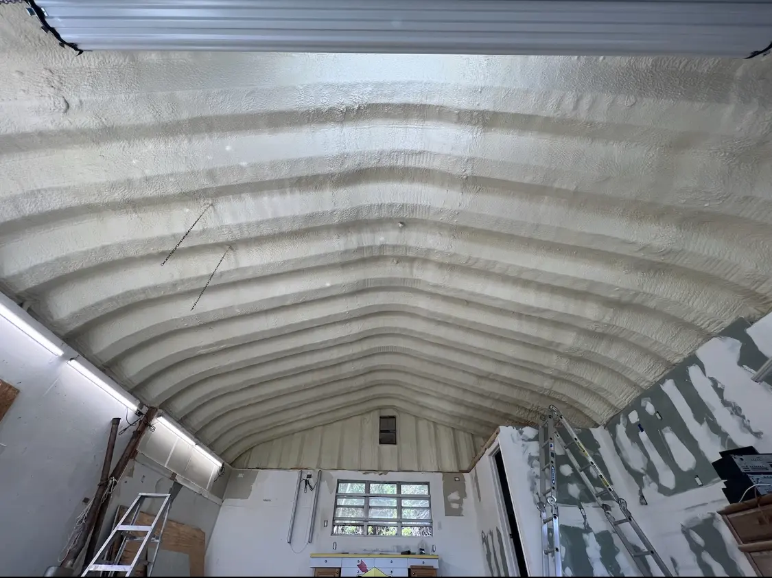 Spray polyurethane foam applied to the underside of a metal roof deck in Parsons